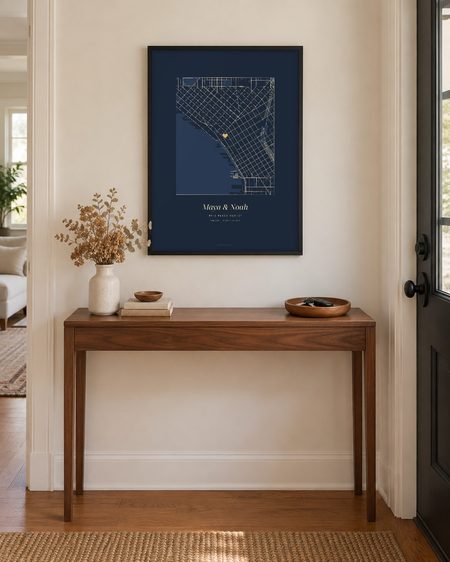Navy map poster, black frame, above a hallway console