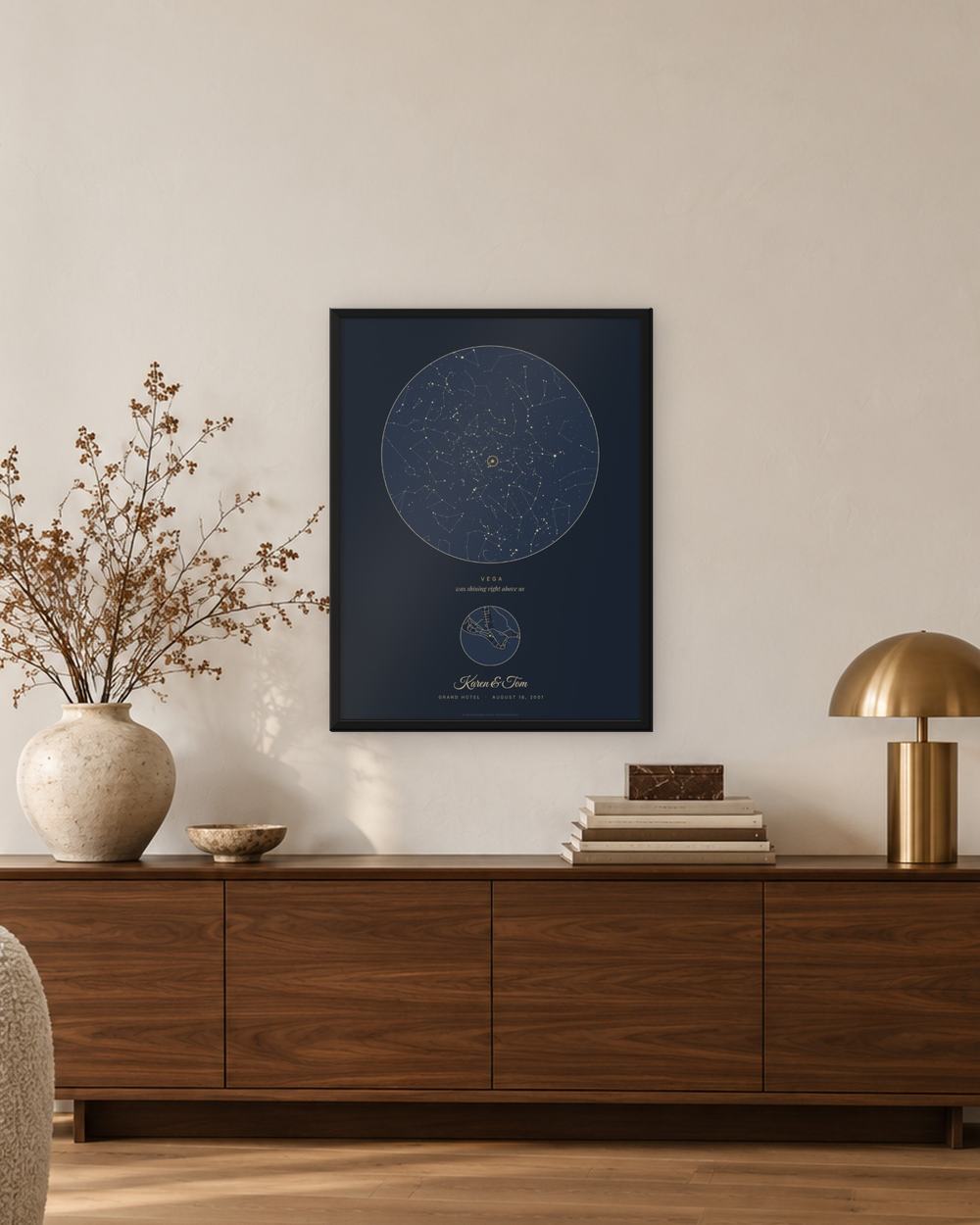 Silver anniversary star map in a black frame above a walnut sideboard, an example: the Navy design for August 18, 2001 on Mackinac Island, names Karen & Tom