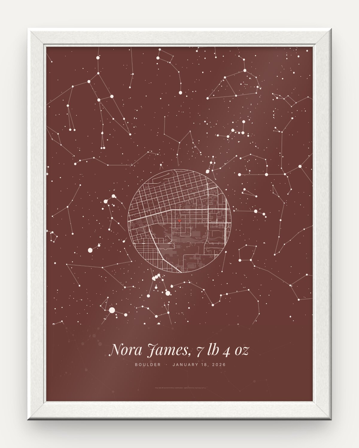 Birth star map poster in a white frame, an example: the whole night sky in Blush over Boulder, Colorado, on January 18, 2026, a round street map of Boulder with a small heart, and the line Nora James, 7 lb 4 oz