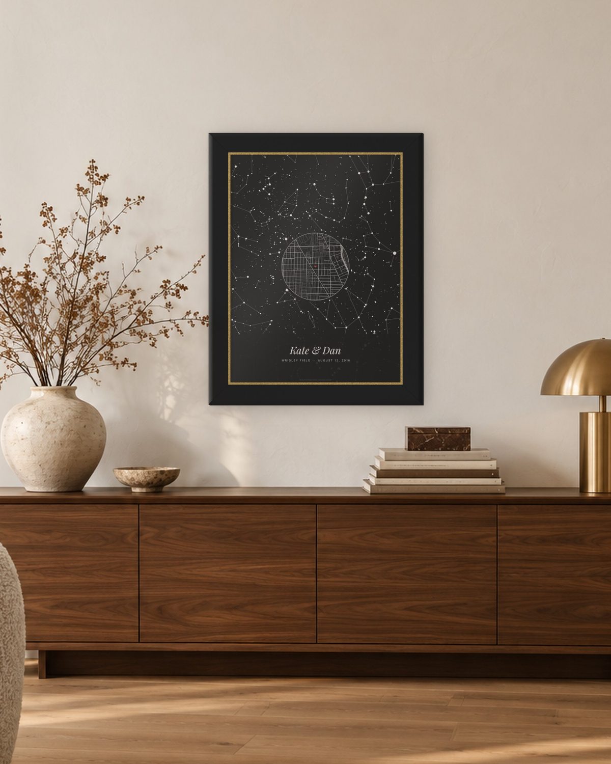 Star map gift for him hung above a walnut sideboard, an example: The whole night in Noir in a black and gold frame, the sky over Wrigley Field, Chicago, on August 12, 2016, a round street map with a heart, and the names Kate & Dan