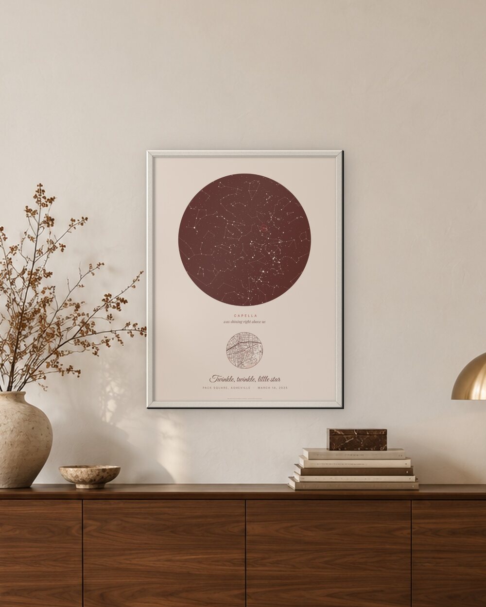 The Twinkle poster framed in white on a living room wall above a walnut sideboard, an example: the Blush Our star poster with the line Twinkle, twinkle, little star